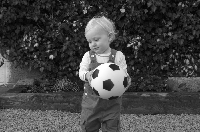 Child portrait of little boy with football