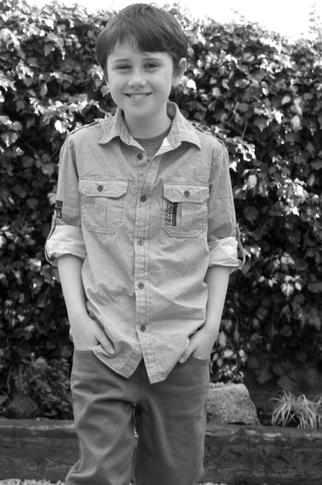 Portrait of young boy in back garden
