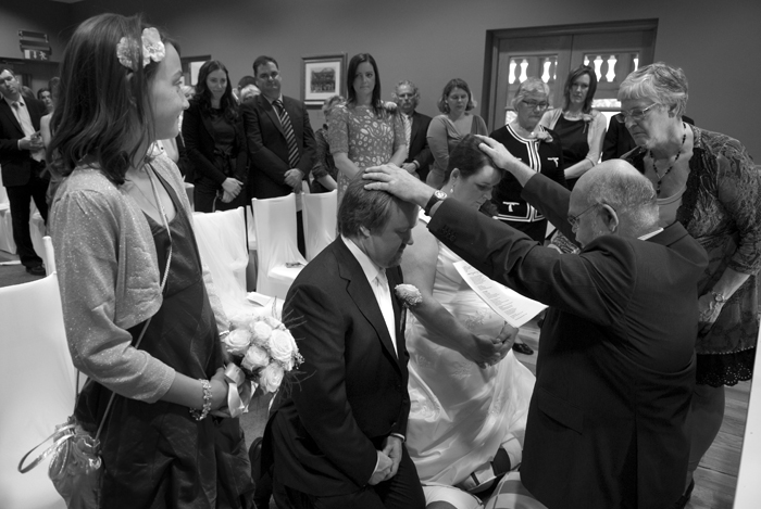 The bride and groom are blessed during their wedding ceremony at the Haughton House at Dublin Zoo