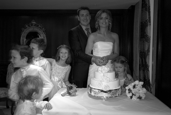 Wedding int The Powerscourt Hotel The bride and groom cut the cake as the flower girls look on during their wedding at The Powerscourt Hotel