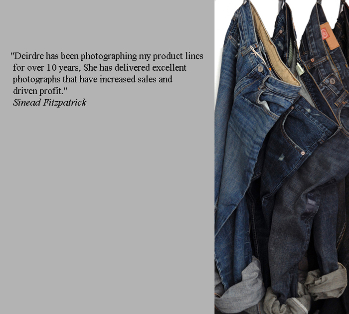 A product photograph of jeans hanging on a rail for a denim fashion line