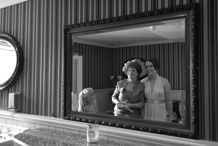 The bride and her mother look in a mirror in Dublin