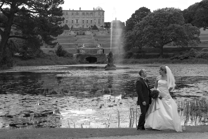 Wedding photograph of the bride and groom by the fountain at Powerscourt Estate