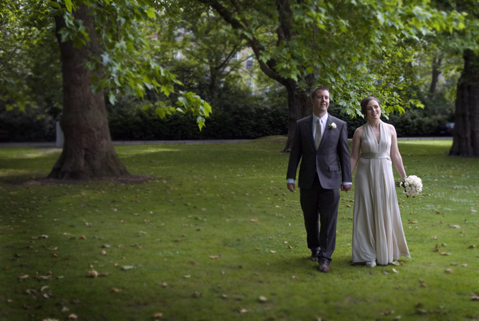 The bride and groom photographed walking through St. Stephen's Green in Dublin