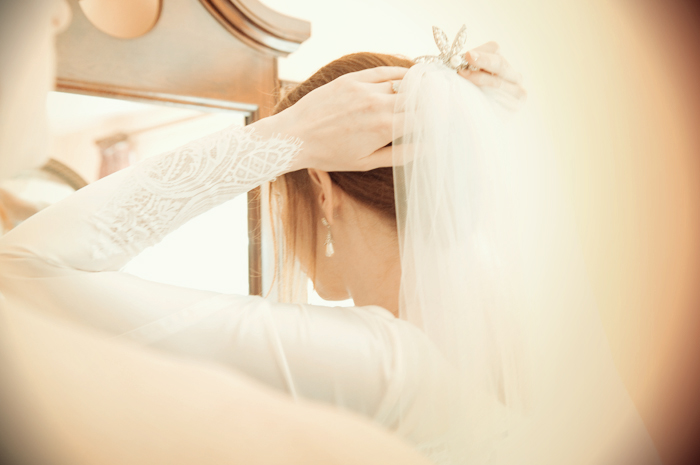 The bride fixes her veil in preparation to be married in a country church in Sneem in Kerry