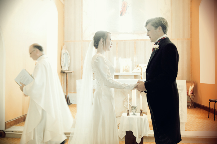 The bride and groom exchange vows during their wedding ceremony in a country church in Sneem on The Ring of Kerry