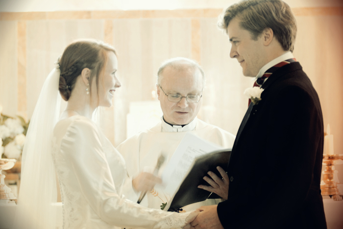 The bride and groom exchange vows during their wedding ceremony in a country church in Sneem on The Ring of Kerry