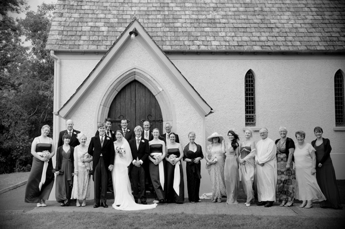 Wedding guests pose for a group portrait outside a country church in Sneem on The Ring of Kerry