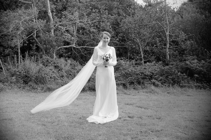 The bride pose for a wedding portrait in the grounds of  a country church in Sneem on The Ring of Kerry