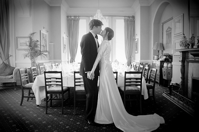The bride and groom kiss in the dining room of the Parknasilla Resort in Sneem Co. Kerry
