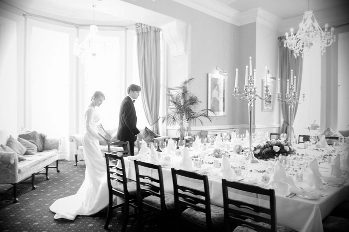 The bride and groom look at the dining table for their wedding reception at the Parknasilla Resort in Sneem Co. Kerry 