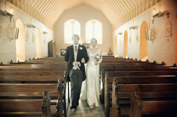 The bride is walked up the aisle to be married in a country church in Sneem on The Ring of Kerry