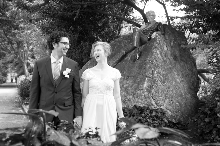 Portrait of the bride and groom by a statue of Oscar Wilde in Merrion Square Park