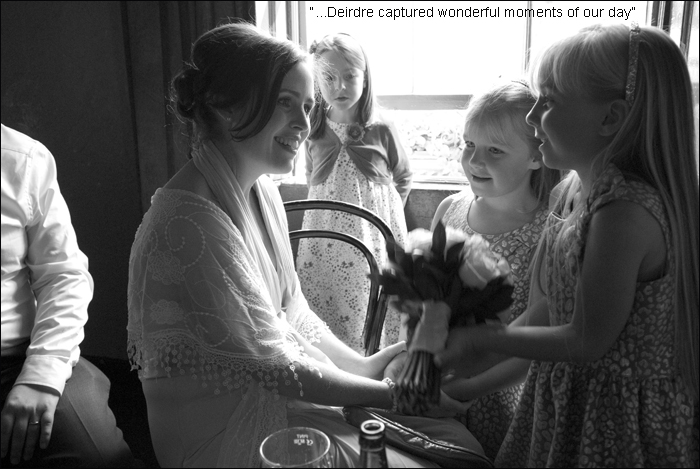 The bride talks to her flower girls during her wedding in Dublin